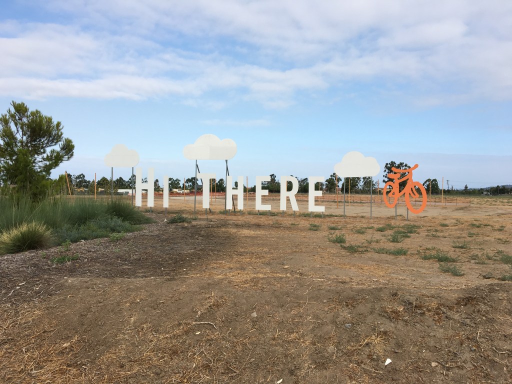 Outdoor image with signage that reads Hi There